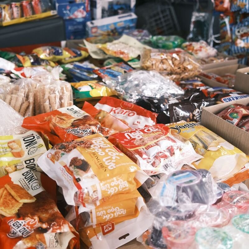 A complete household grocery haul cleanly laid out on an organic wood table