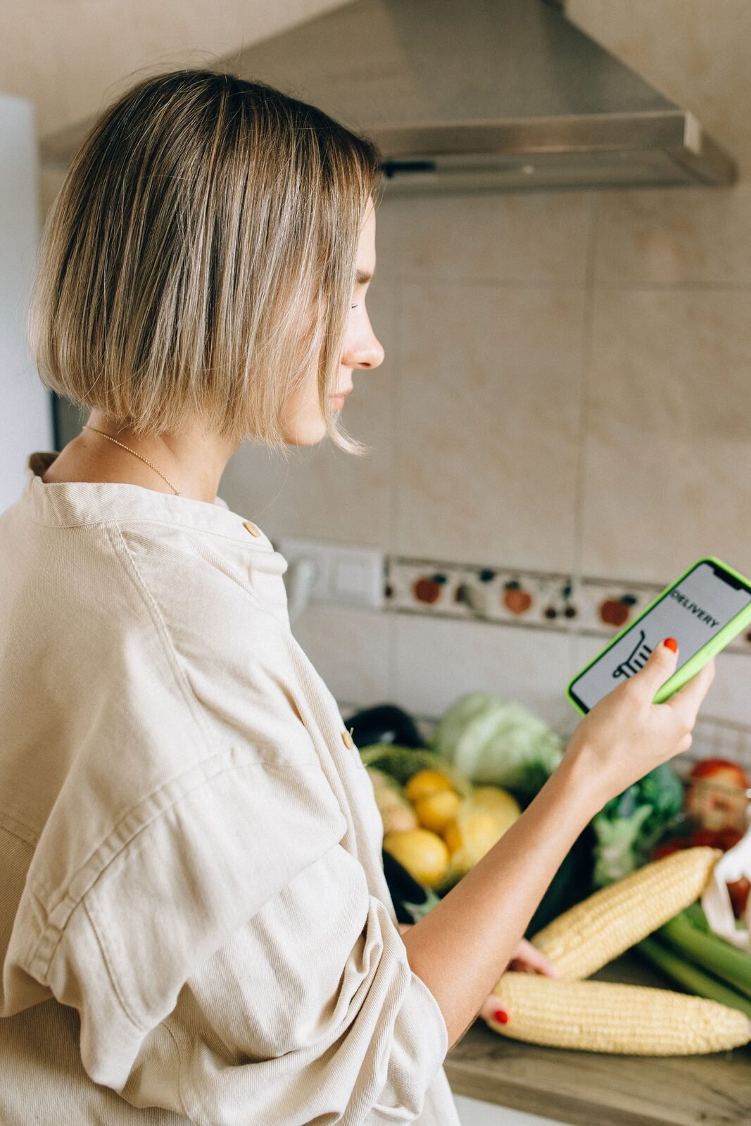 Choosing a grocery box on a phone in the kitchen